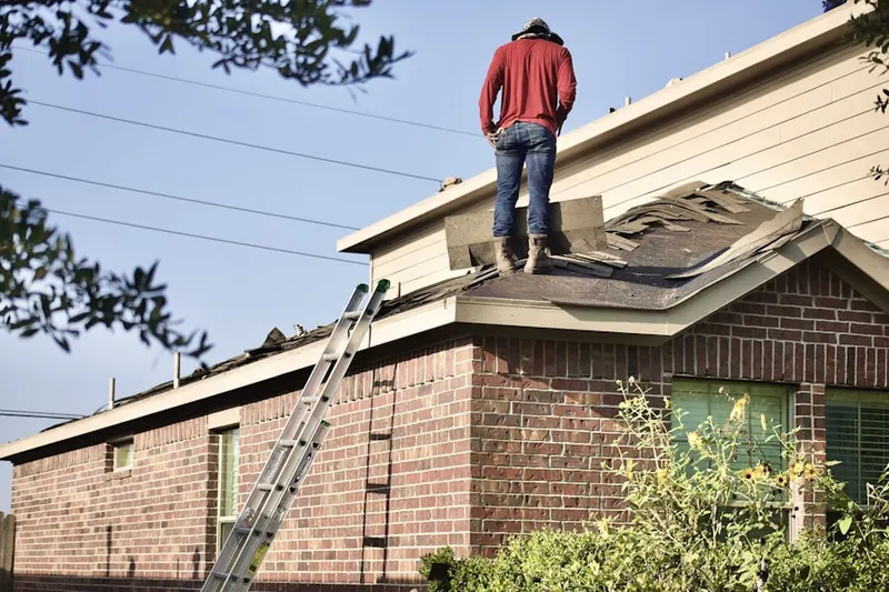 Professional roofer working on a residential roof in Pavilion